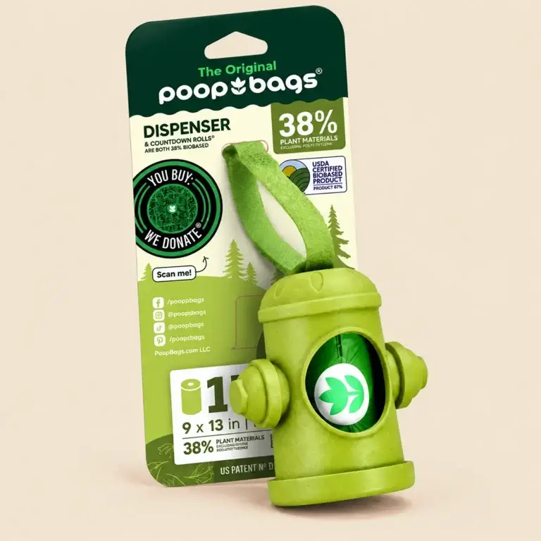 Green dog poop bag dispenser with leash strap and retail packaging